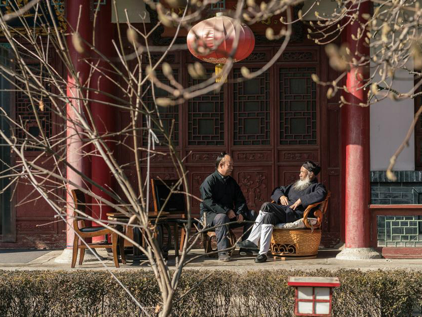 <p>Ren Farong (right) chats with another monk in a courtyard at Louguantai Temple, Tayu Village, Shaanxi province. (Image: Thomas Cristofoletti for Sixth Tone)</p>