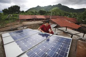 woman assembles solar panel