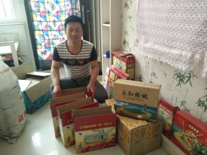 Liu Dongdong, one of China's new rural e-commerce entrepreneurs, is pictured with boxes of red dates  