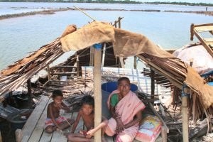 A woman and her family under a temporary shelter after the landfall of Cyclone Amphan. Source: Alamy