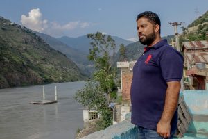 Man looks out over flooded river