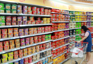 a women shopping for instant noodle in a supermarket