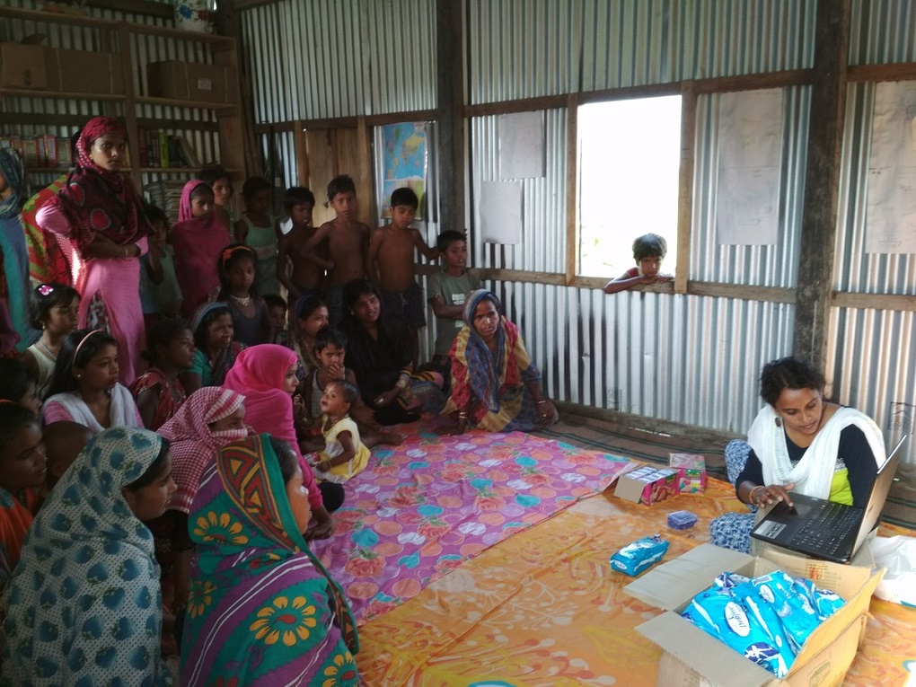Women’s rights worker Manjuwara Mullah discussing menstrual hygiene with the young women of the char [image by: Abdul Kalam Azad]