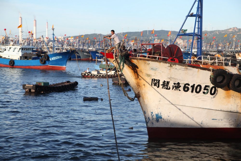 A fishing vessel gets ready to set out to sea from a Fujian province harbour