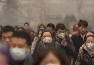 People wearing face masks on their way to work in Beijing, China.