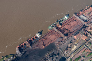 aerial image of cargo vessels loading on the Parana River at Muelle Carbon Siderar in the port of Barrio 7 de Septiembre, San Nicolas de los Arroyos,