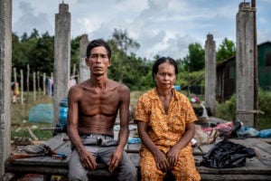 <p>Youn Yoeurn (left) and Yen Soth have lost their home and a large portion of the land it was on to a new coal-fired power plant being built in the district of Botum Sakor on Cambodia’s coast. The couple have been compensated for the land but not their house, which they borrowed US$5,000 to help build. (Image: Roun Ry / China Dialogue)</p>