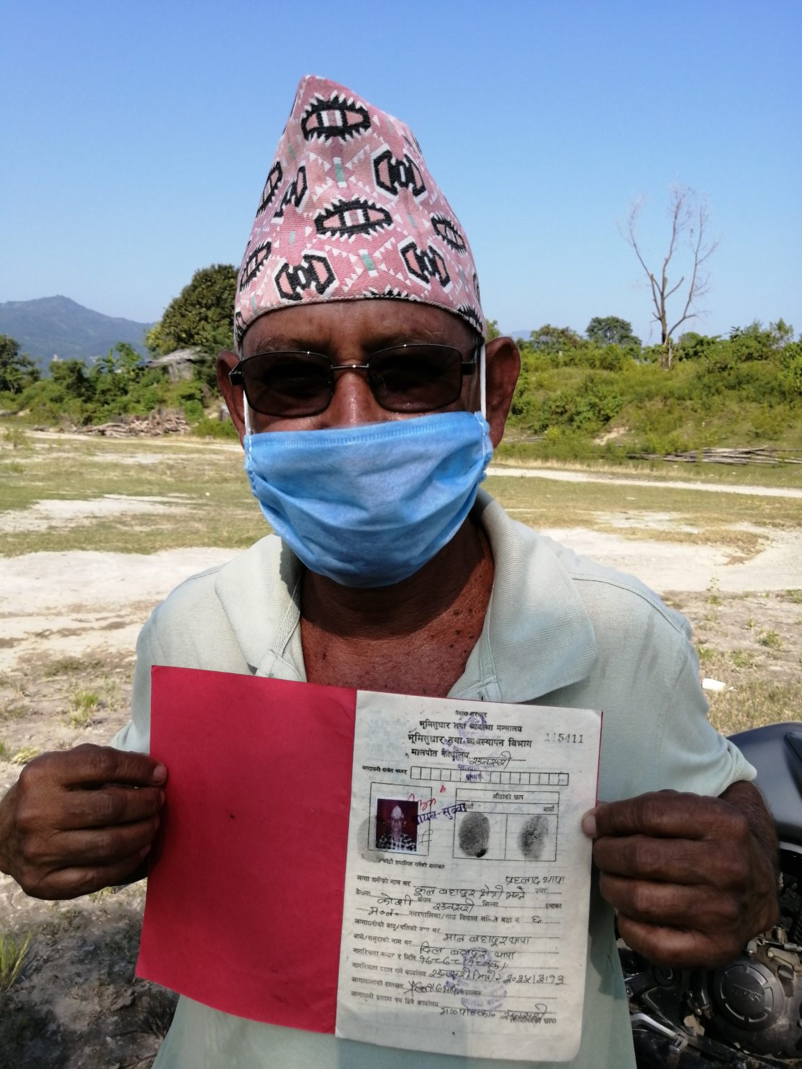 Prahlad Thapa with the document proving his ownership of land [Image by: Birat Anupam]
