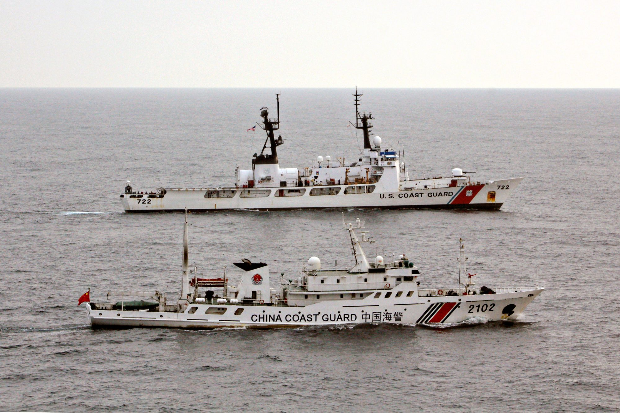 <p>US Coast Guard Cutter Morgenthau steams alongside the Chinese Coast Guard vessel 2102 as they transfer custody of the fishing vessel Yin Yuan detained for illegal fishing. (Source: <a href="https://www.alamy.com/image-details-popup.asp?imageid=b61f0026-bd4f-4e0d-8ea5-c356bb0c1f97&amp;srch=&amp;Stamp=3&amp;imageType=0">Alamy</a>)</p>