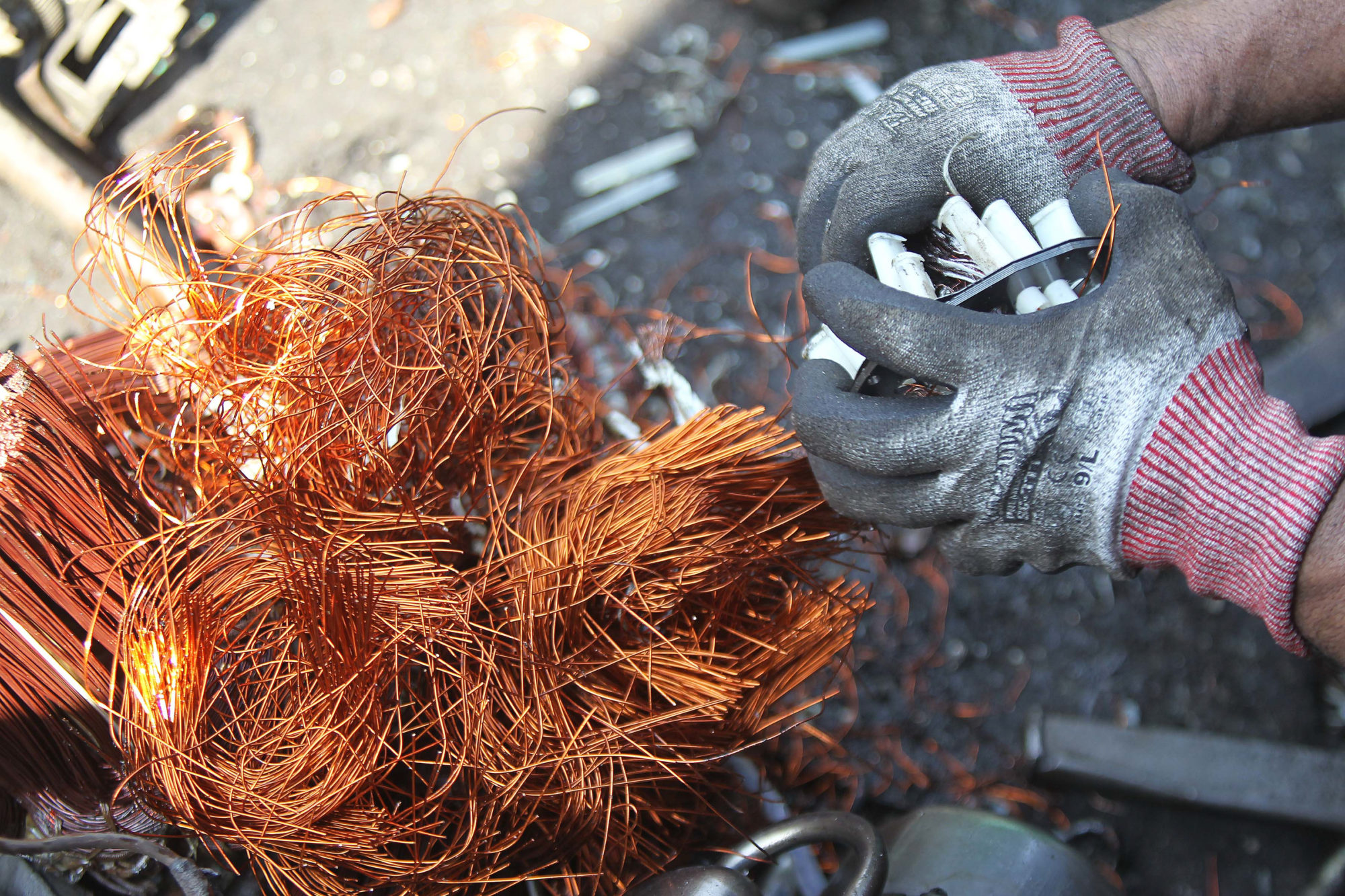 <p>Collecting copper wires from a dismantled washing machine in the Philippines (Image: <a tabindex="-1" href="https://media.greenpeace.org/archive/Electronic-Waste-Worker-in-Manila-27MZIFJJTQ5AG.html">Greenpeace</a>)</p>