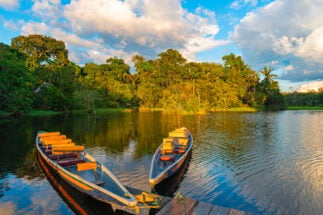 Two traditional wooden canoes at sunset in the Amazon River Basin
