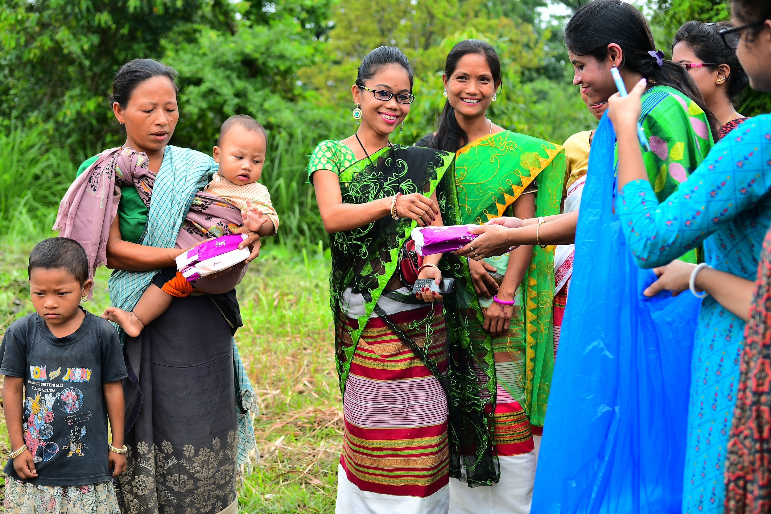 <p>Health workers distributing free sanitary pads to women and girls in a health camp in the Indian state of Tripura [image by: Abhisek Saha / SOPA Images / ZUMA Wire / Alamy Live News]</p>