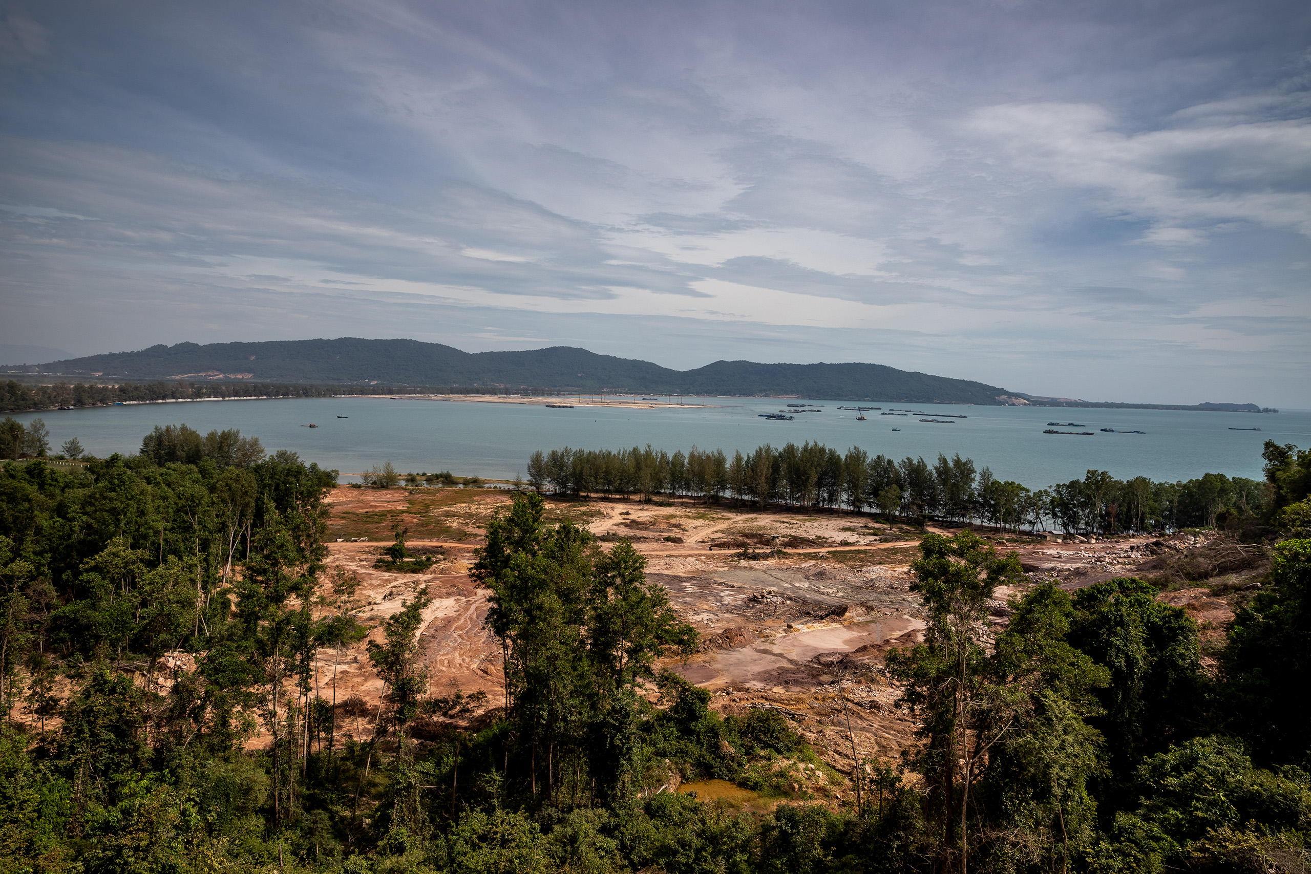 Just outside the Ream National Park, boats dredge for sand to reclaim a large area of land
