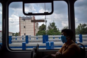 <p>A man travels on an electric bus during the Covid-19 pandemic in Kolkata, India (Image: Sudipta Das / Pacific Press / Alamy Live News)</p>