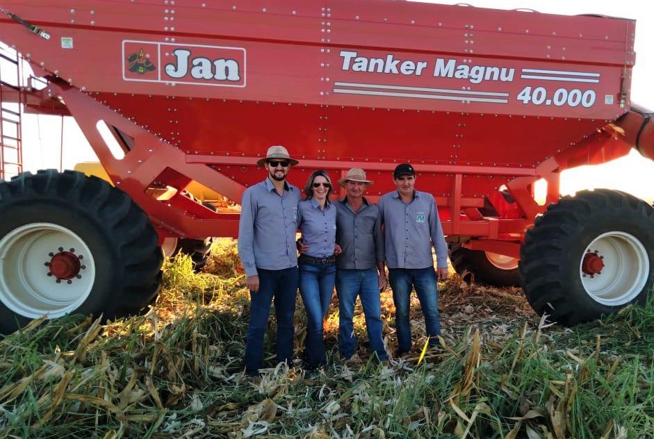 Luciane May and her family pose in front of a tractor