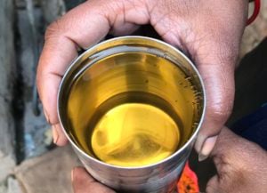 <p>A villager shows a water sample taken from Sheikhpura village in the district of Muzaffarnagar. Contaminated groundwater is often all that people have to drink if they cannot afford bottled water. (Image: Monika Mondal / The Third Pole)</p>