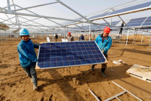 workers install solar panels in Jiangsu