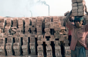 A man carrying bricks at Fatullah Brick Factory near Dakha, in Bangladesh.