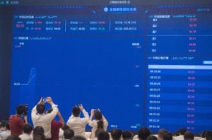 A screen in Wuhan shows data on China's national carbon market, on the day trading began