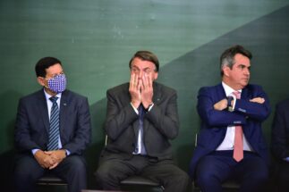 Jair Bolsonaro sits with vice-president Hamilton Mourão and minister Ciro Nogueira