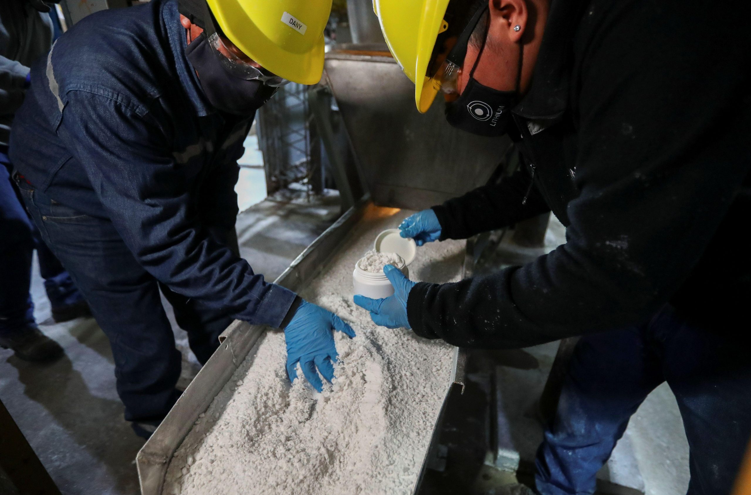 Workers handle lithium carbonate