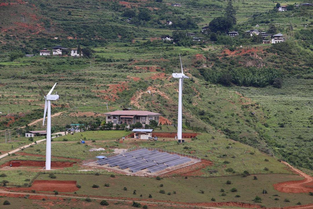 <p>A 180kW solar plant in Wangduephodrang district has been built next to an existing wind farm. Officials say this is the first of many such projects. (Image: Department of Renewable Energy, MoEA Bhutan)</p>