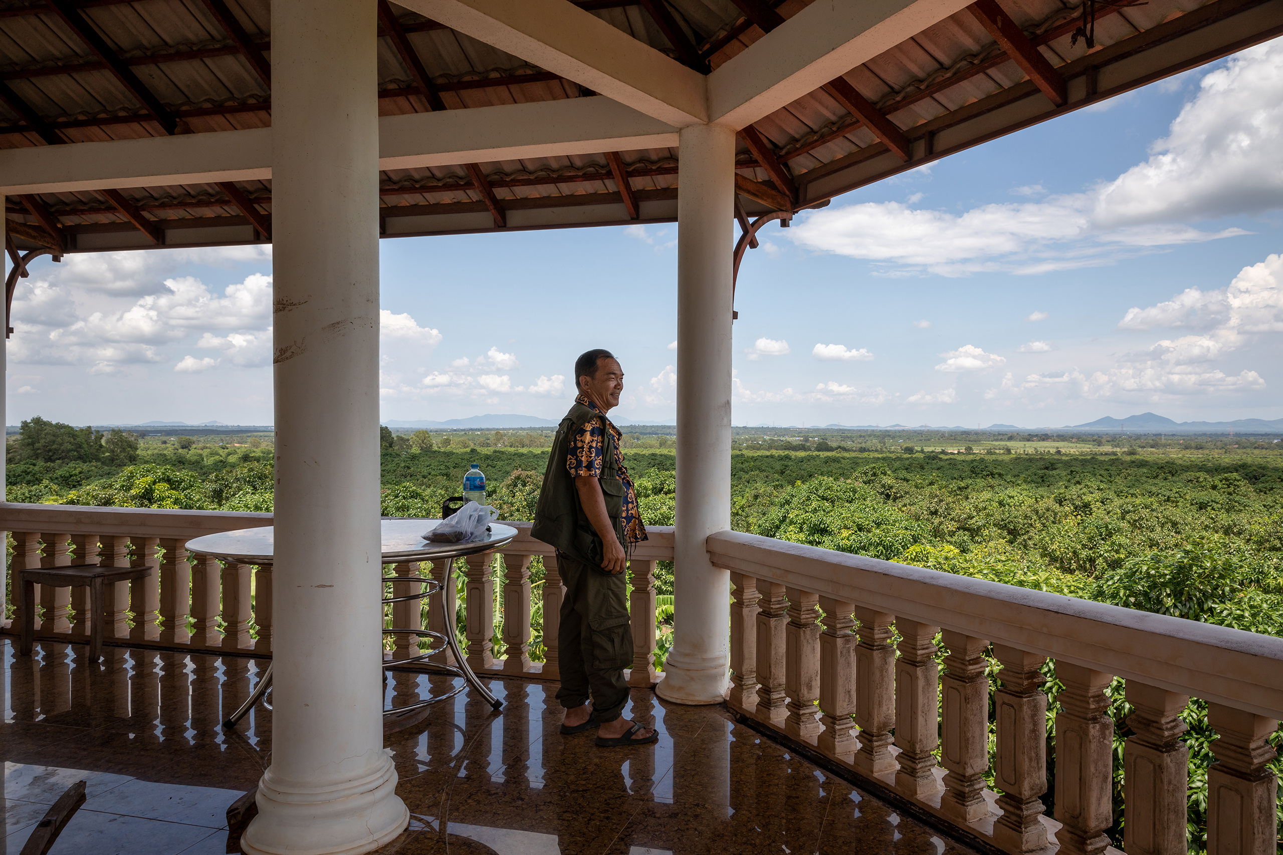 Chhim Chamroeun’s husband and business partner William Lor looks out over a mango plantation