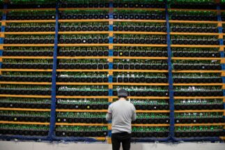 A worker checks the fans at a cryptocurrency farming operation
