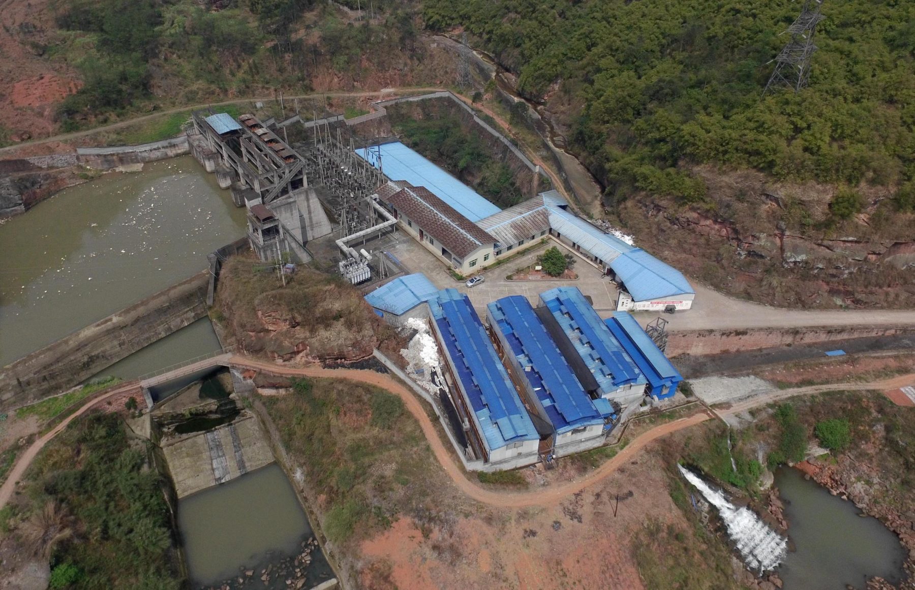 An aerial view of a bitcoin farm next to a hydropower station