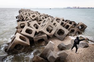 <p>A sea wall protects the port of Dongjiang in the northern Chinese city of Tianjin. The port has been built largely on reclaimed land, and is one of the busiest in the world. (Image © <a href="https://gallagher-photo.com/">Sean Gallagher</a>)</p>