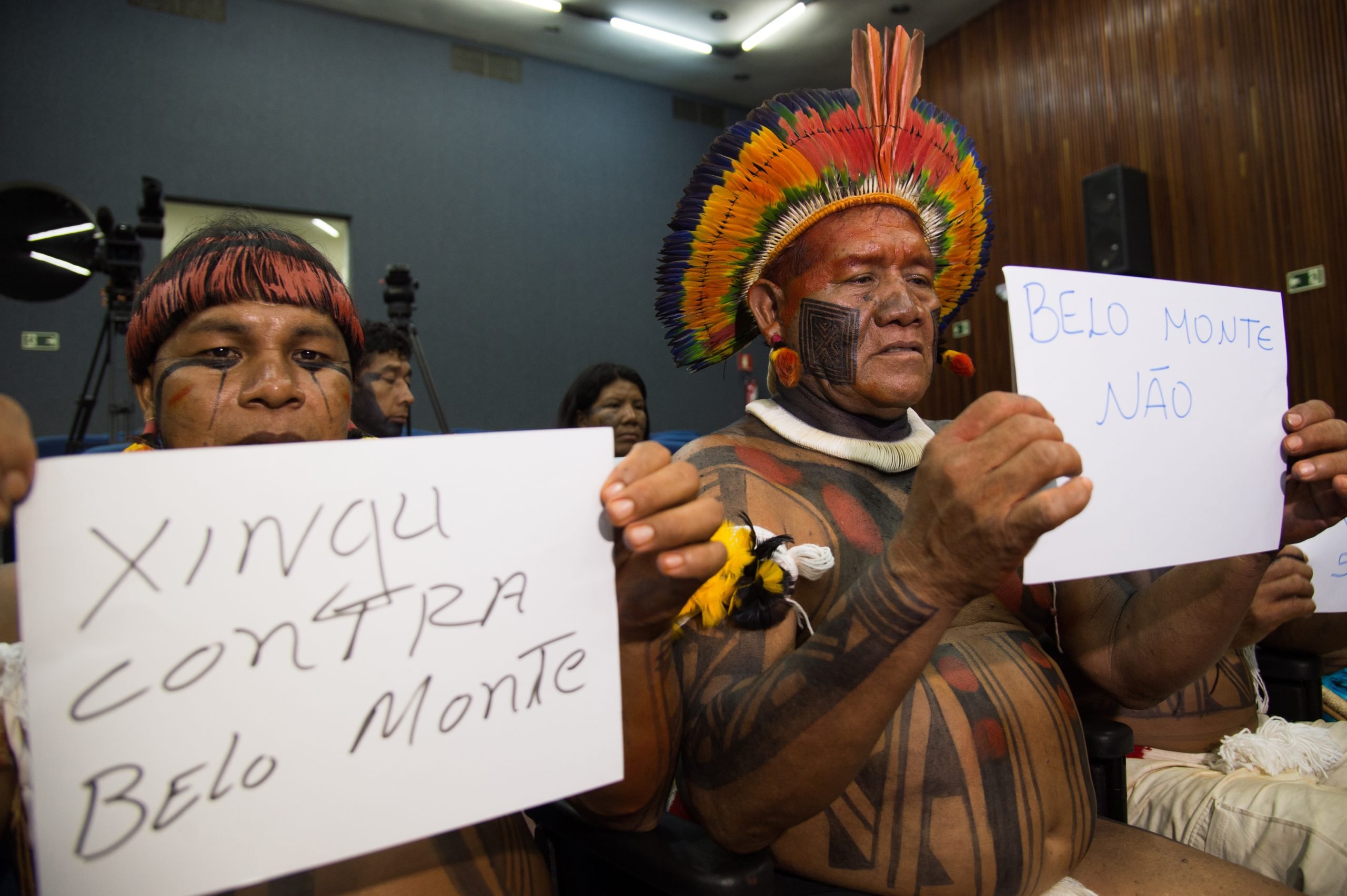 Indigenous people with signs saying "Xingu against Belo Monte".