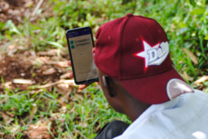 <p>Leonard Maritim checks for storm activity using an innovative phone app before planting maize on his farm in western Kenya (Image: Dominic Kirui / China Dialogue)</p>