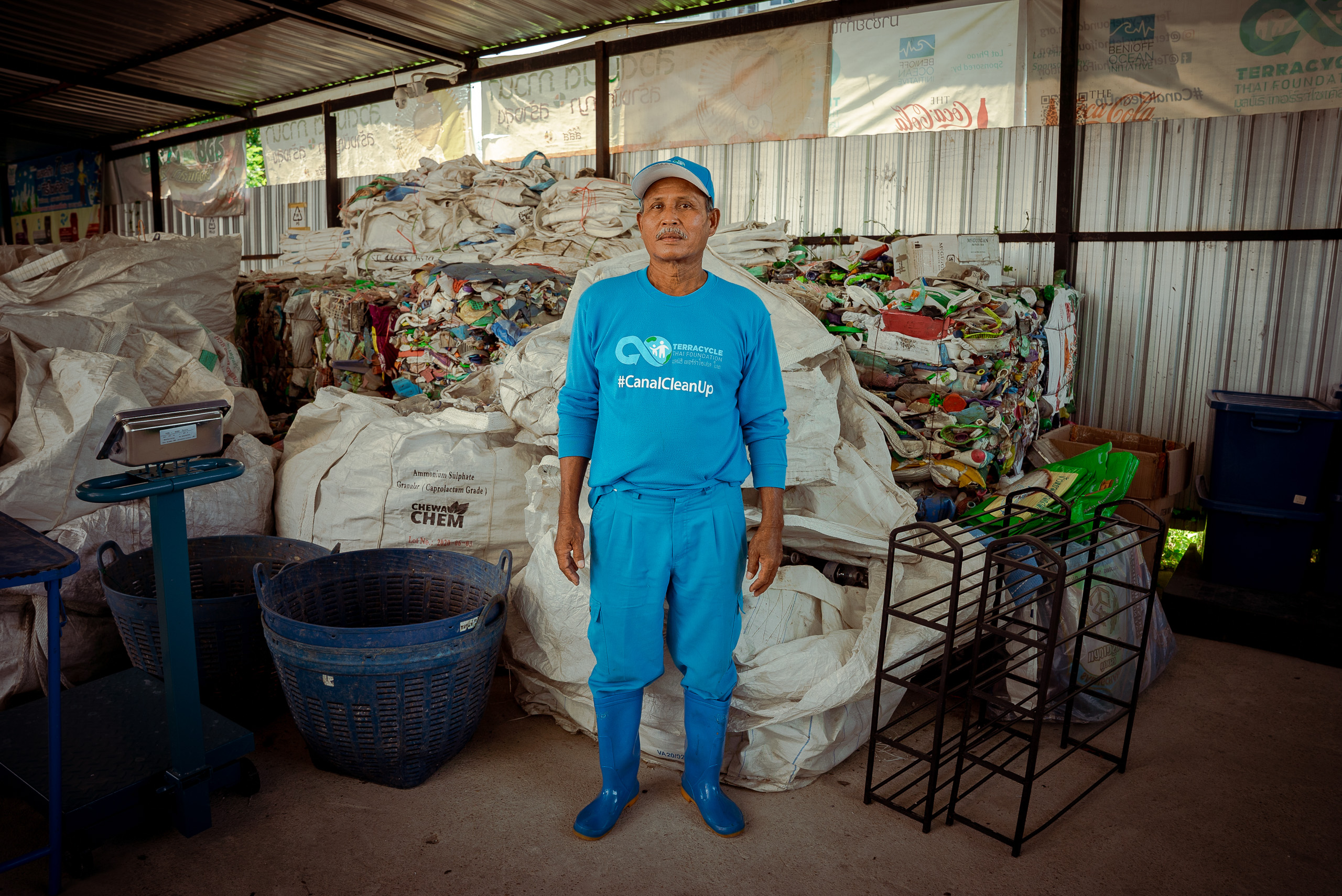 man standing in front of pile of sacks