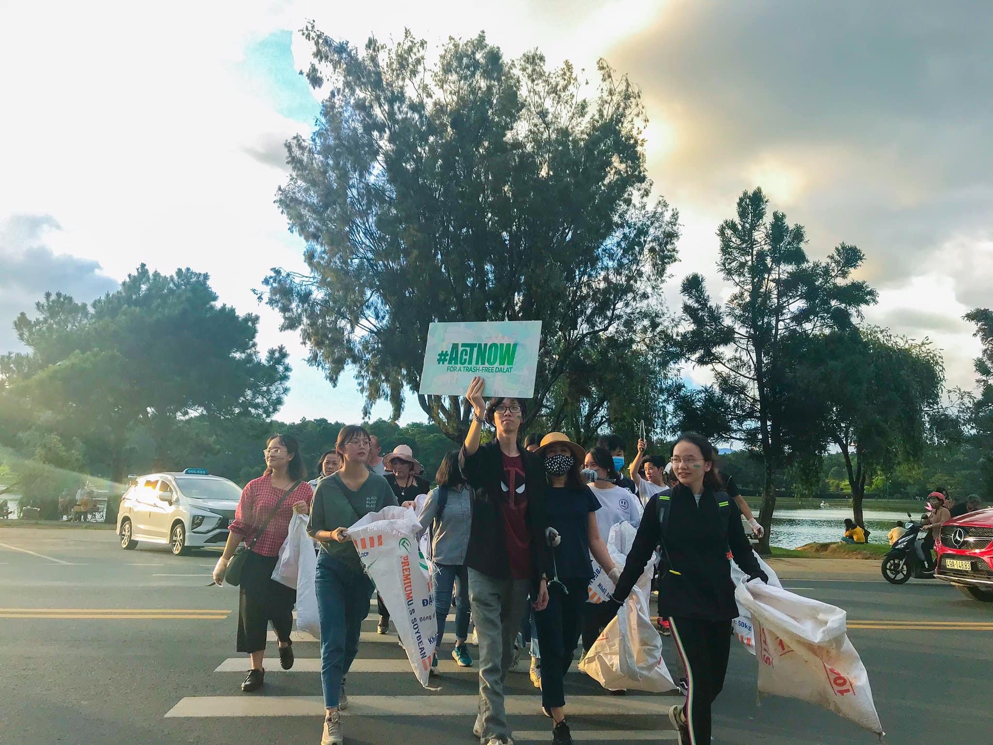 group of people on zebra crossing carrying placcards and sacks