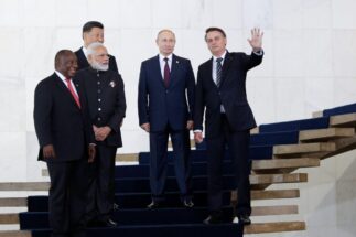 South African President Cyril Ramaphosa, Indian Prime Minister Narendra Modi, Chinese President Xi Jinping, Russian President Vladimir Putin and Brazilian President Jair Bolsonaro stand on a staircase.