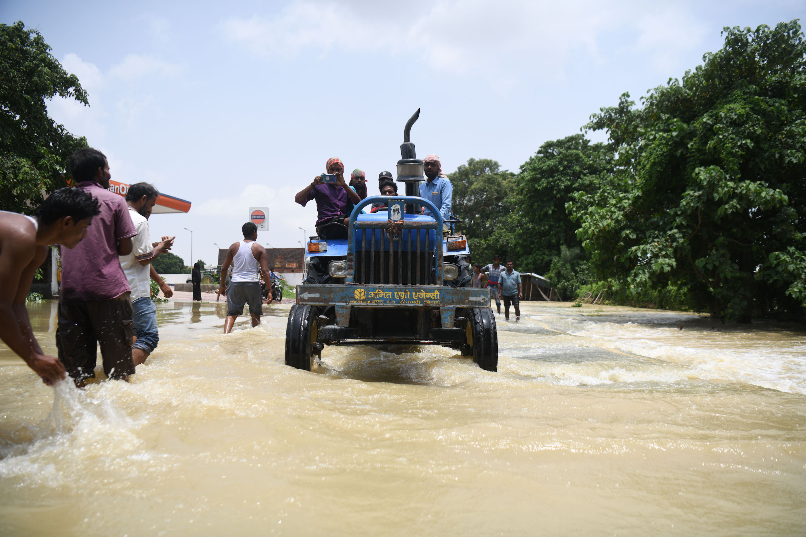 <p>People use a tractor to navigate floodwaters in Muzaffarpur district, in India’s Bihar state, in 2020 (Image: Sachin Kumar)</p>