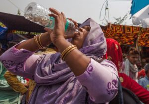 <p>A woman drinks water at a marketplace during a hot day in India. On 18 April 2023 several northern and eastern cities recorded maximum temperatures above 44 degrees Celsius. (Image: Javed Dar/Alamy)</p>