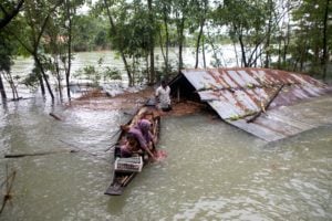 <p>A family flees a flood-affected area by boat in Sylhet, Bangladesh, June 2022. This year&#8217;s flooding has been worsened by unusual wind patterns linked to climate change, experts say (Image: Alamy)</p>