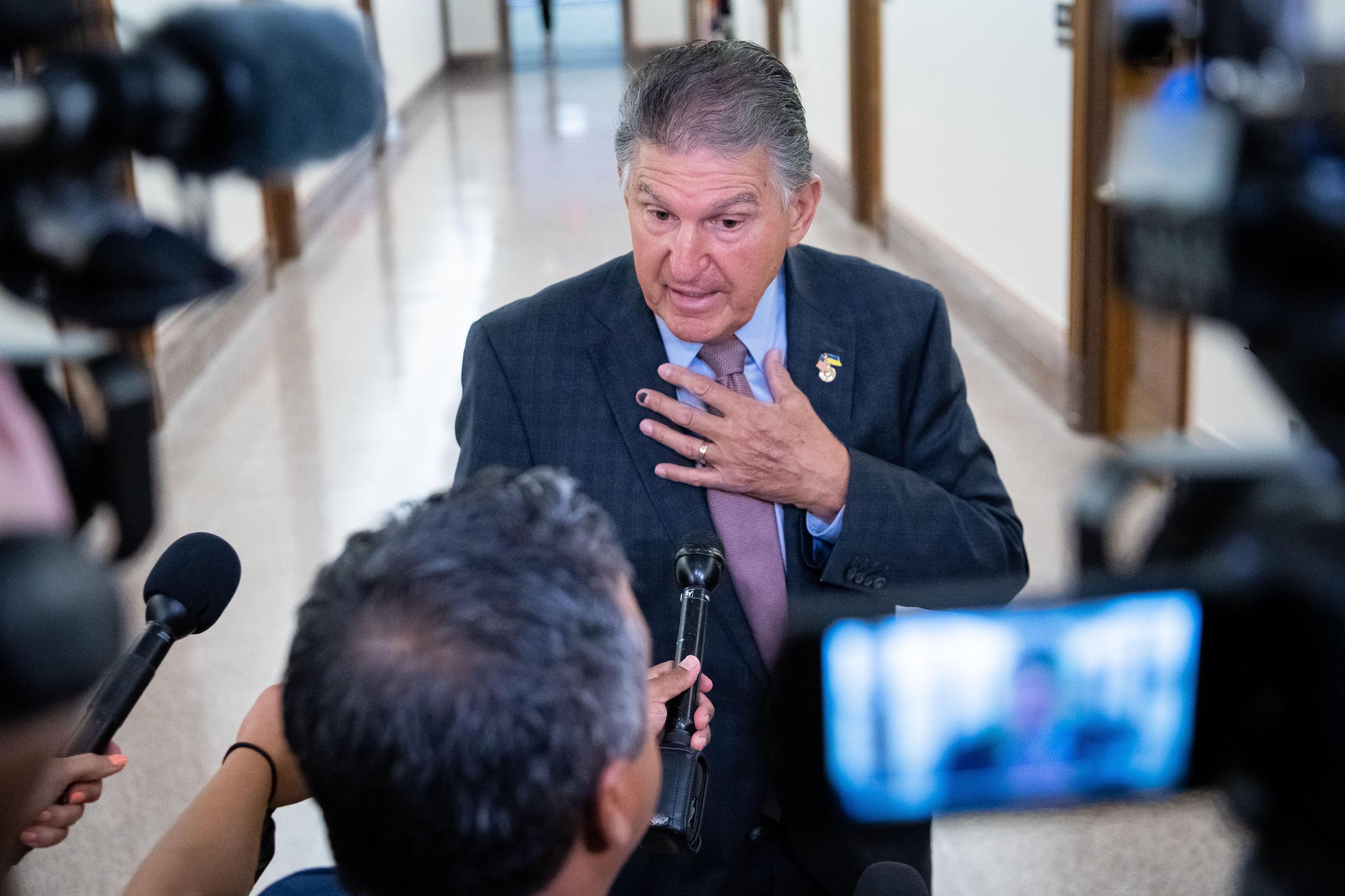 <p>Senator Joe Manchin speaks to media ahead of an Energy and Natural Resources Committee hearing in the Senate, Washington DC, 19 July (Image: Graeme Sloan / Alamy)</p>