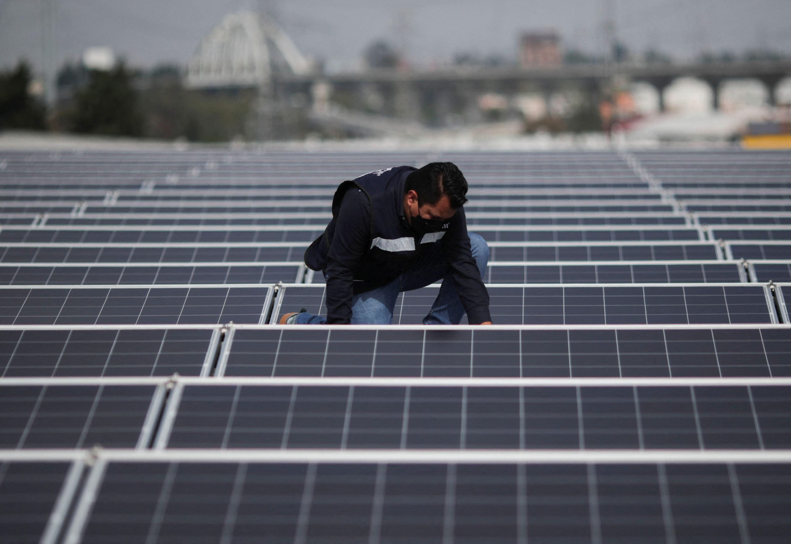 <p>An engineer installs a solar panel in Mexico in August this year. Regionally, it is <a href="https://wedocs.unep.org/handle/20.500.11822/34532">estimated</a> that US$621 billion could be saved by reaching net zero in the energy and transport sector alone. (Image: Henry Romero / Alamy)</p>