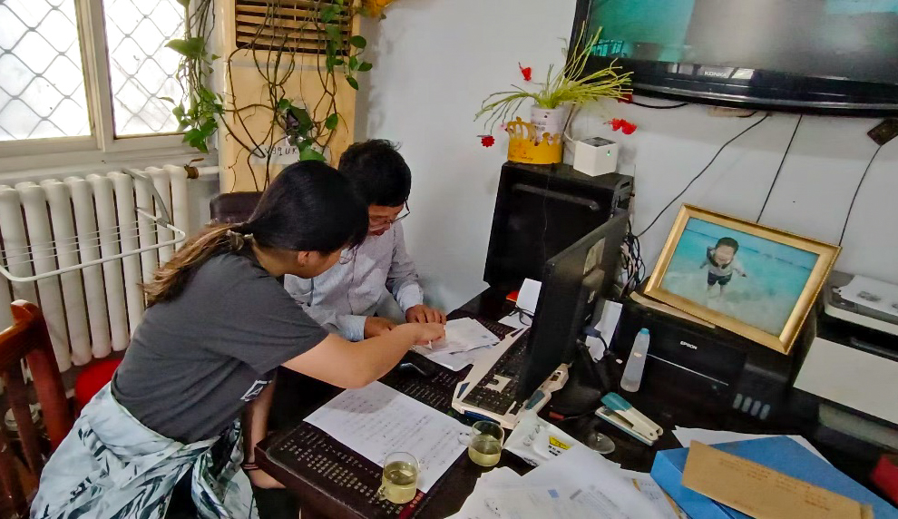 A volunteer helps the Blue Bay Centre with paperwork 