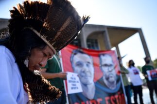 <p>An indigenous protestor demonstrates outside Brazil’s Ministry of Justice in June, following the disappearance of Dom Phillips and Bruno Pereira in the Amazon. Their murders drew global attention to the dangers environmental defenders face in the region (Image: Antonio Molina / Foto Arena / Alamy)</p>