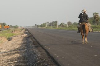 <p><span style="font-weight: 400;">A cattle farmer rides along a nearly completed section of the Bioceanic Corridor, a project seeking to improve connectivity through Paraguay’s Gran Chaco (Image: Santi Carneri/Diálogo Chino)</span></p>