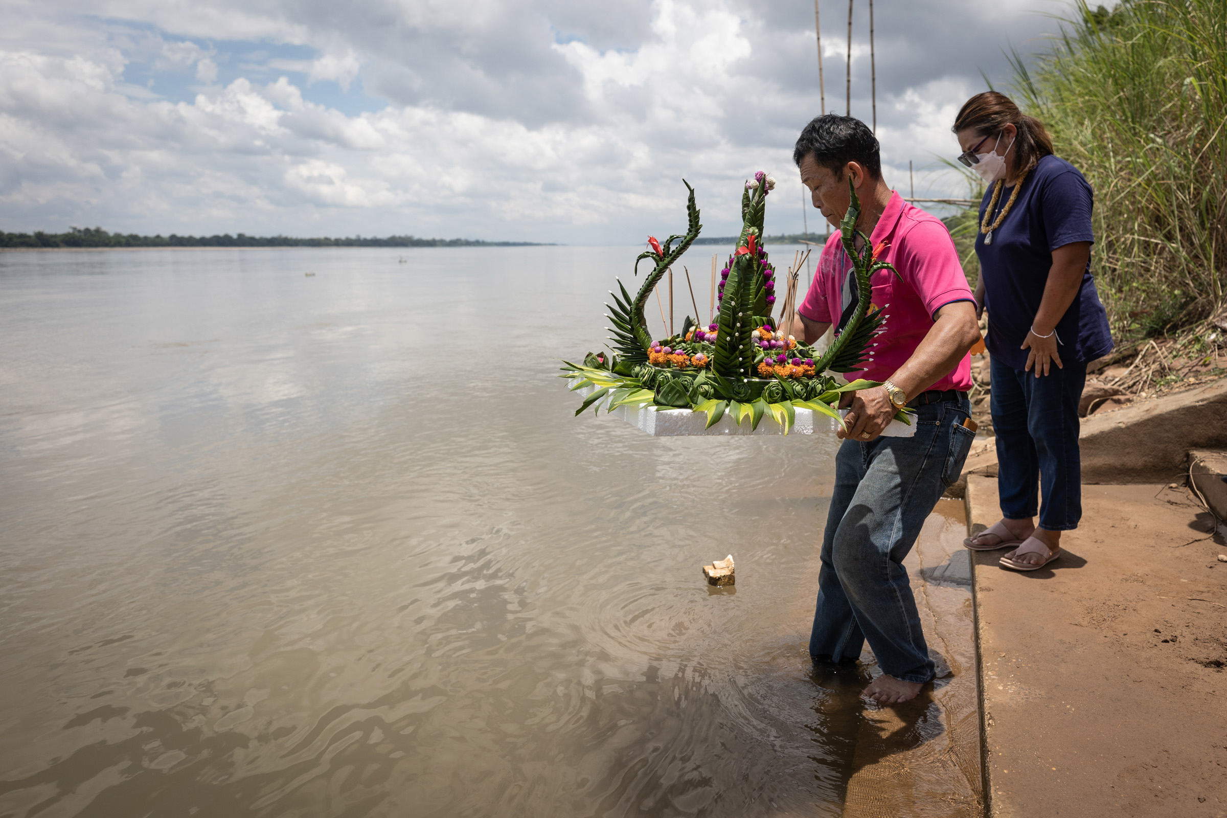 placing a float on the Songkhram River as part of the Bun Bang Fai festival