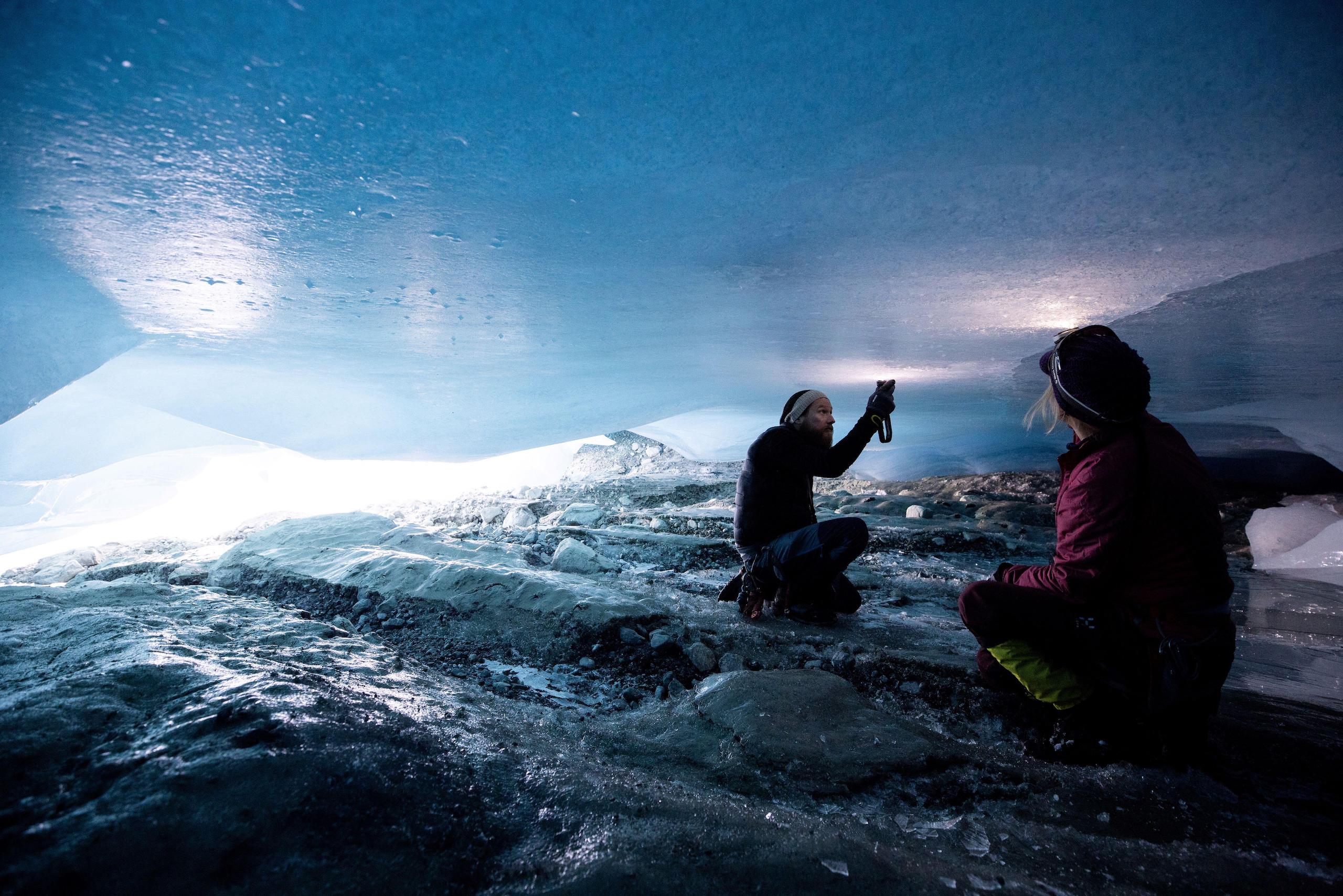 <p>Glaciologists inspect a crack in the ceiling of a natural glacier cavity of the Jamtalferner glacier in Austria. Giant ice caves have appeared in glaciers, accelerating the melting process faster than expected as warmer air rushes through the ice mass until it collapses. (Image: Lisi Niesner / Alamy)</p>