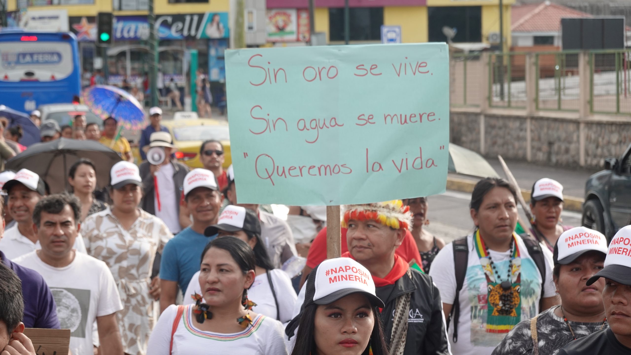 A protestor at a demonstration against illegal mining in Tena, Napo province, Ecuador, holds a sign saying "Without gold, we live. Without water, we die. We want to live"