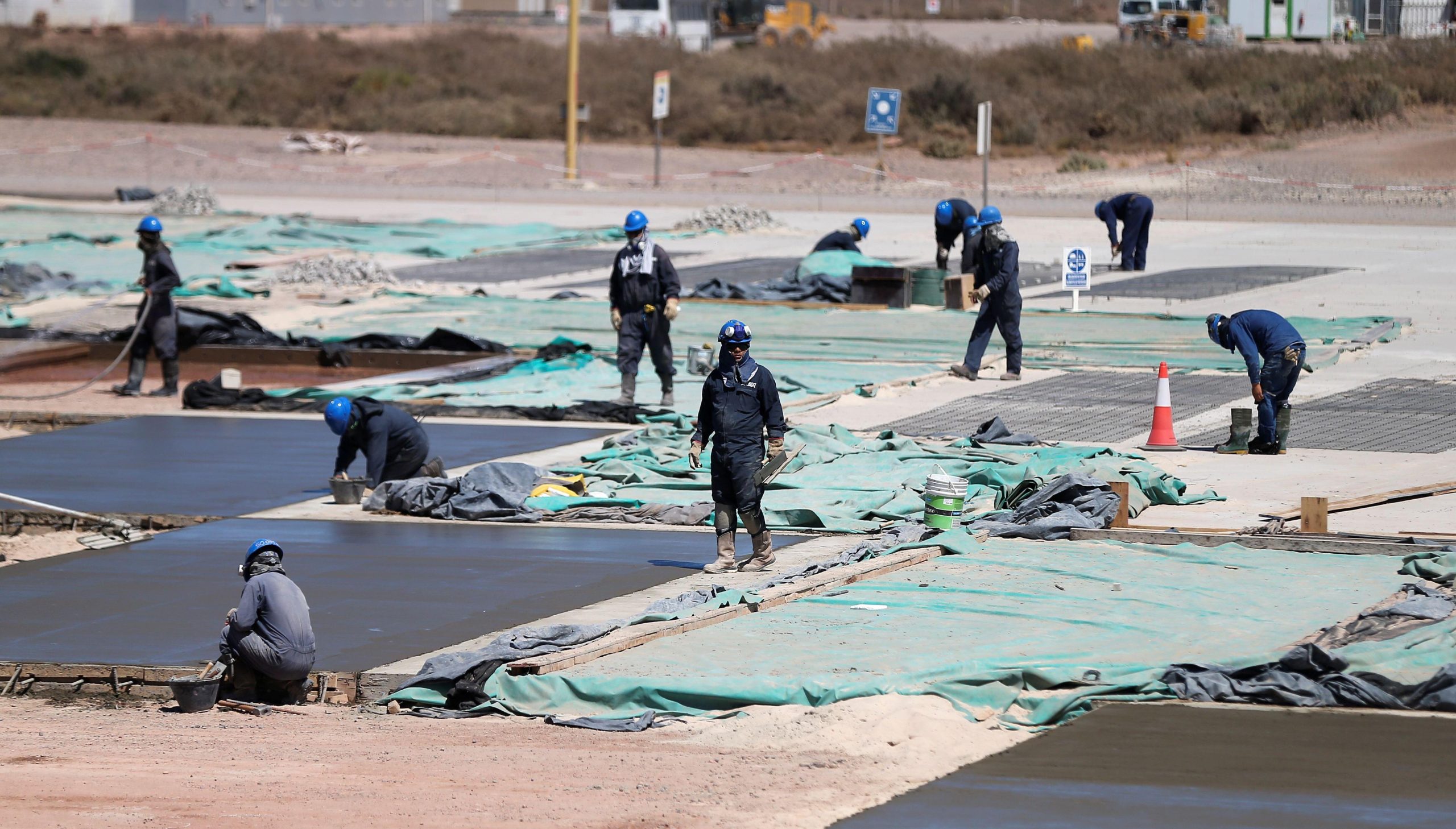 Workers at a sand refinery for fracking projects at Vaca Muerta fields in Argentina