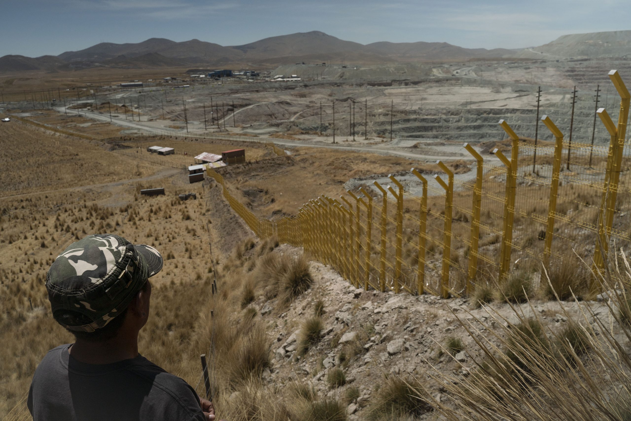 A man overlooks a copper mine on Peru's mining corridor