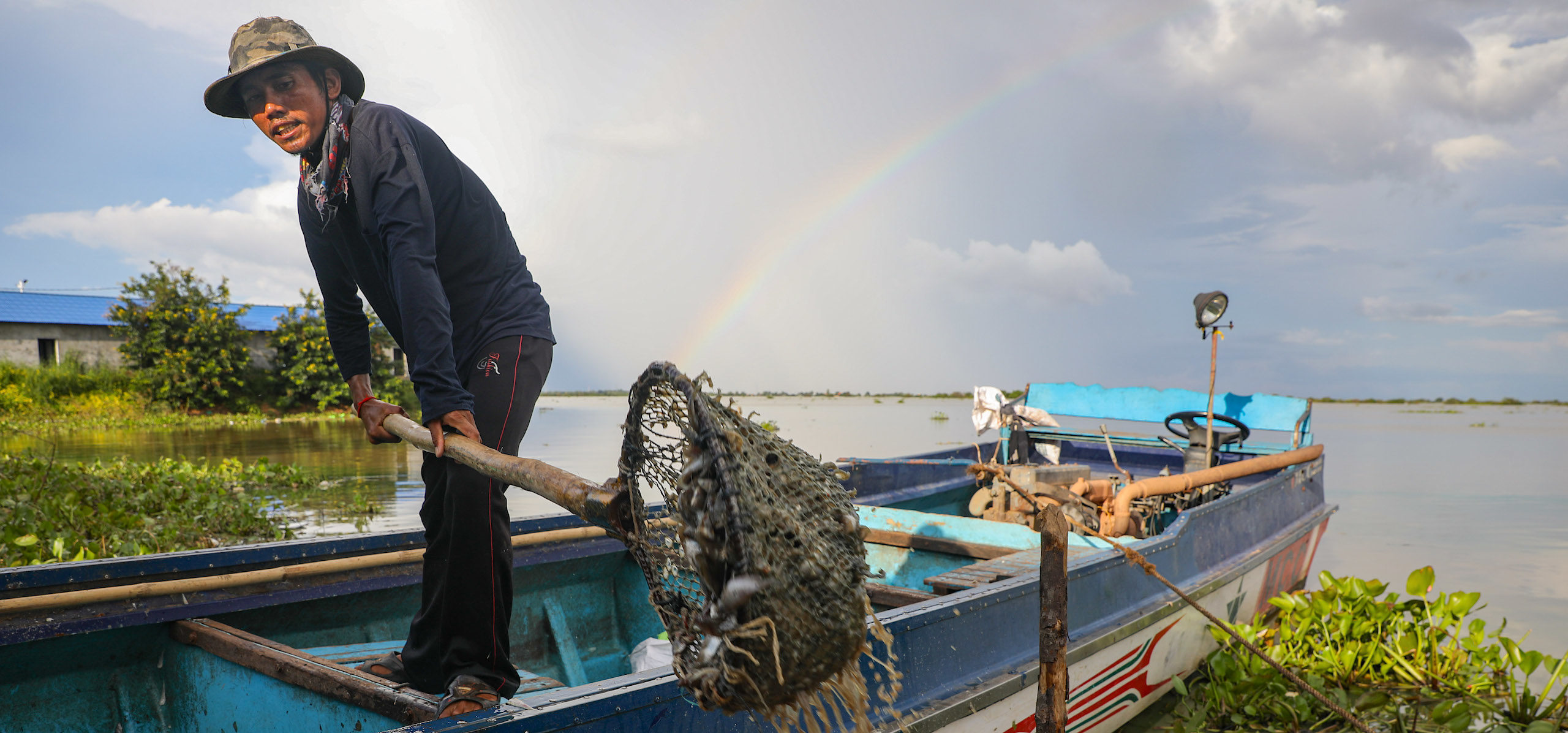 <p>Fisher Ly Houy unloads what he calls a “poor catch” at Kampong Khleang, a floating village on Cambodia’s Tonle Sap Lake (Image: Anton L. Delgado)</p>