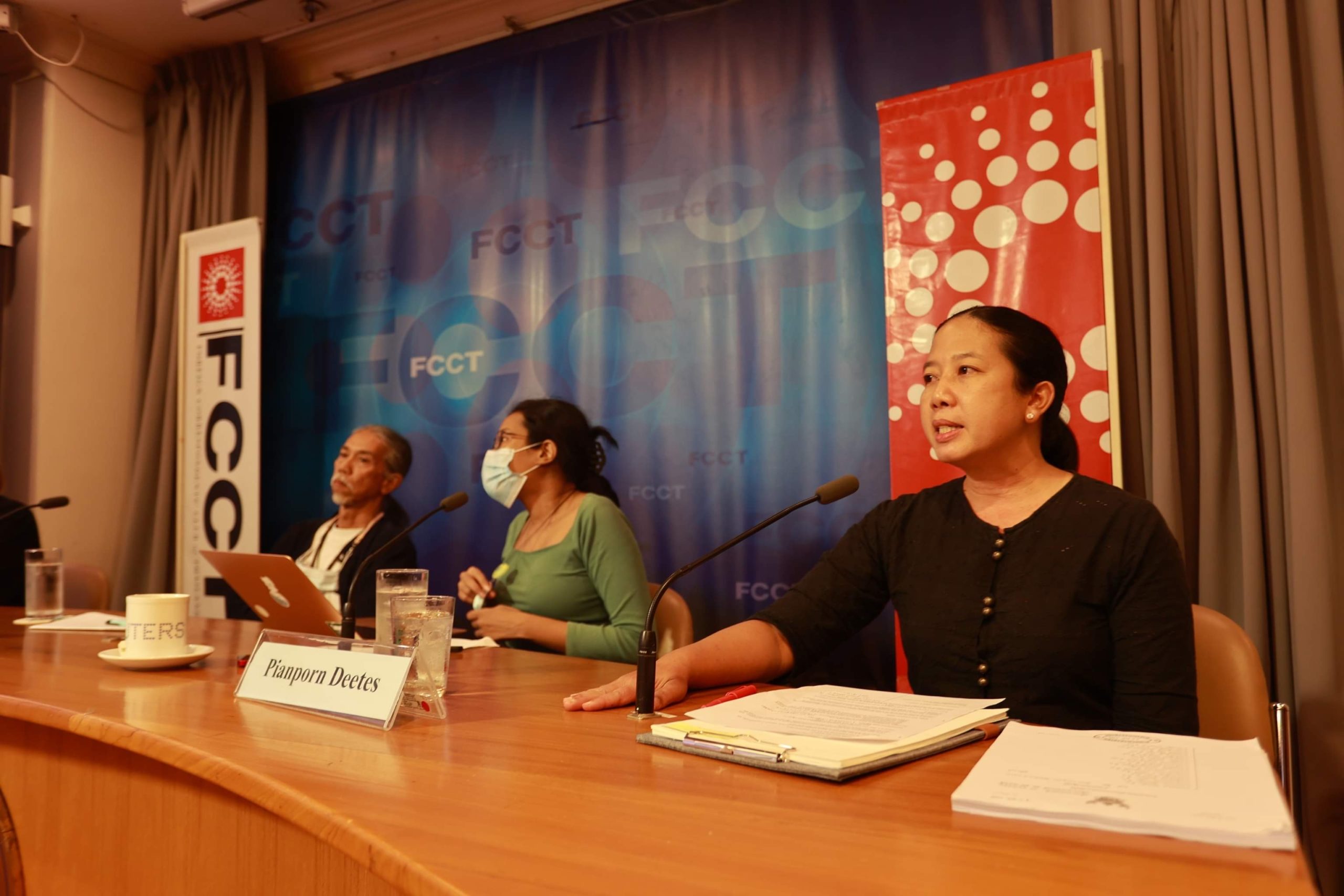 Pianporn (Pai) Deetes at a panel table